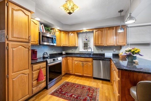 19 Beal Rd, Waltham, MA 02453 - kitchen with stainless steel appliances, a sink, and light wood-style floors