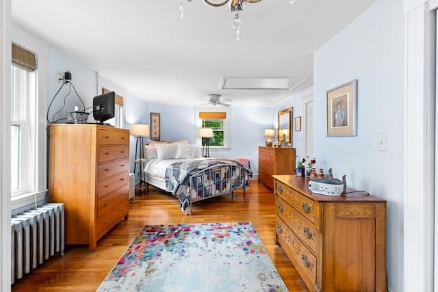 19 Beal Rd, Waltham, MA 02453 - bedroom featuring radiator, light wood-type flooring, attic access, and ceiling fan