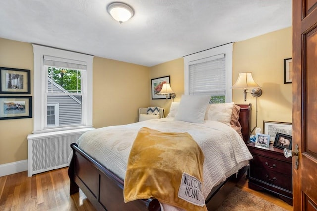 19 Beal Rd, Waltham, MA 02453 - bedroom with radiator, wood finished floors, and baseboards