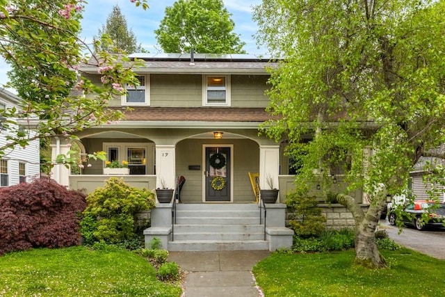 19 Beal Rd, Waltham, MA 02453 - view of front of house with covered porch, solar panels, and roof with shingles