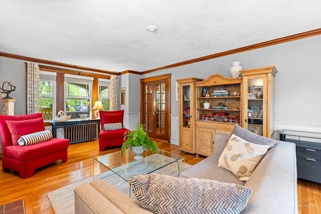 19 Beal Rd, Waltham, MA 02453 - living area featuring crown molding, wood finished floors, radiator heating unit, and a wainscoted wall