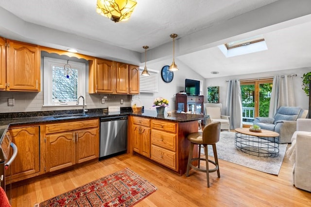 19 Beal Rd, Waltham, MA 02453 - kitchen with stainless steel dishwasher, a sink, a skylight, open floor plan, and lofted ceiling