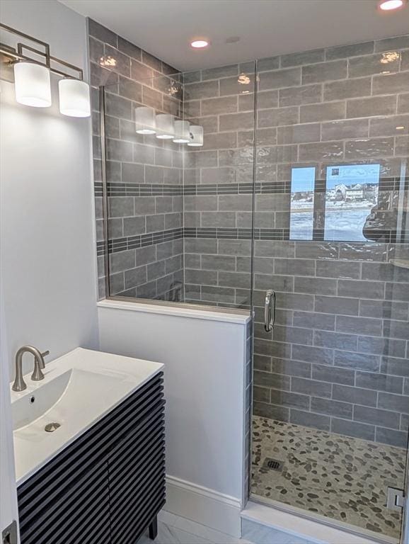 bathroom featuring recessed lighting, vanity, marble finish floor, and a shower stall