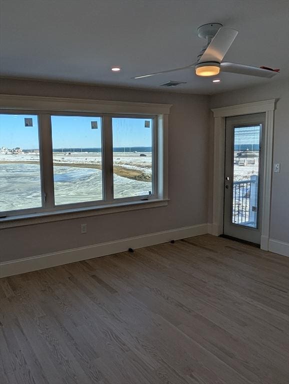 spare room with recessed lighting, visible vents, baseboards, and wood finished floors