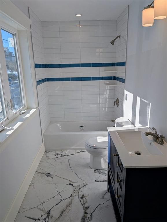 full bath featuring vanity, baseboards, toilet, marble finish floor, and shower / bathtub combination