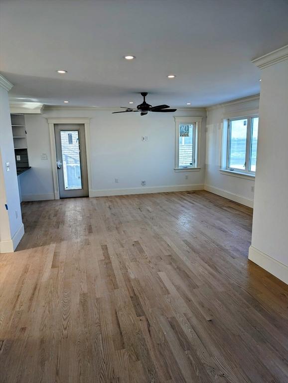 unfurnished living room with recessed lighting, baseboards, and wood finished floors