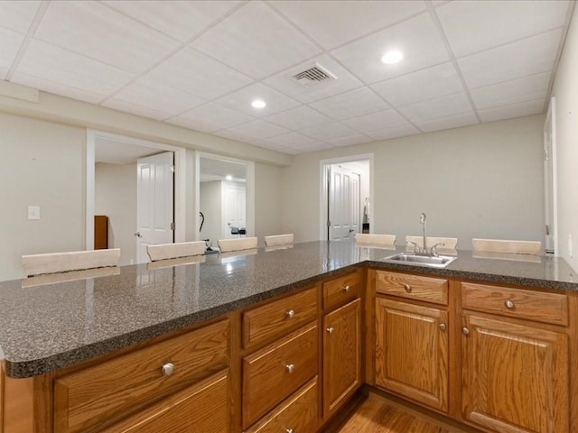 26 Silver Brook Ln Unit 26, Norwell, MA 02061 - kitchen featuring brown cabinetry, dark stone counters, wood finished floors, a paneled ceiling, and recessed lighting
