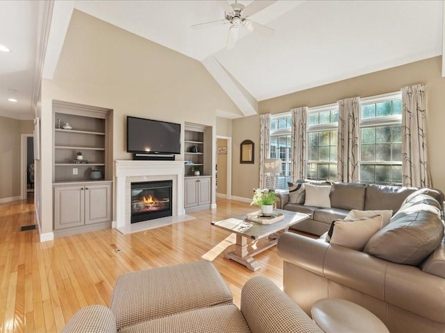 26 Silver Brook Ln Unit 26, Norwell, MA 02061 - living room featuring built in shelves, light wood finished floors, ceiling fan, a fireplace with flush hearth, and lofted ceiling