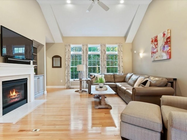 26 Silver Brook Ln Unit 26, Norwell, MA 02061 - living area featuring ceiling fan, vaulted ceiling, a glass covered fireplace, and wood finished floors