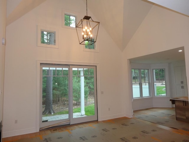 83 Johnson Woods Dr Unit 83, Reading, MA 01867 - entryway featuring high vaulted ceiling, baseboards, and a chandelier