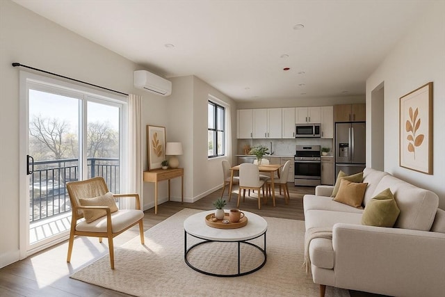 43-47 Fremont Unit 9, Boston, MA 02126 - living area with baseboards, a wall mounted AC, and light wood-type flooring