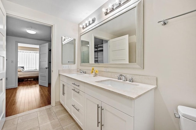 bathroom with tile patterned floors, vanity, and toilet