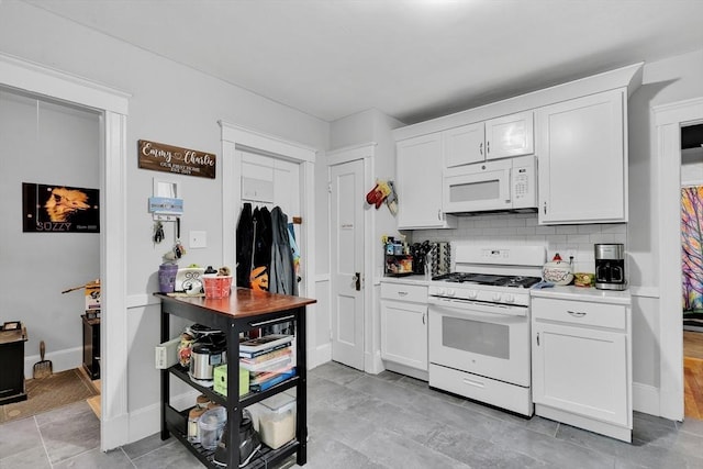 kitchen featuring white appliances, white cabinetry, light countertops, and backsplash