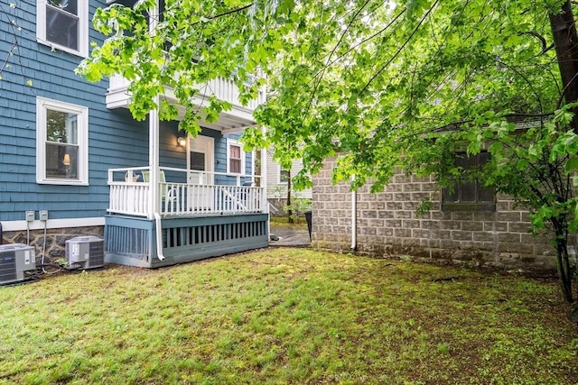 view of yard featuring central air condition unit and a deck