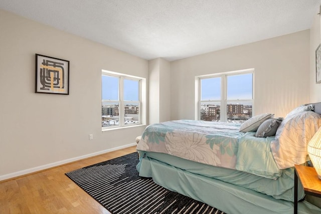 bedroom with wood-type flooring and a textured ceiling