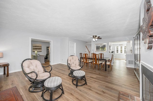 sitting room featuring baseboards, visible vents, and wood finished floors