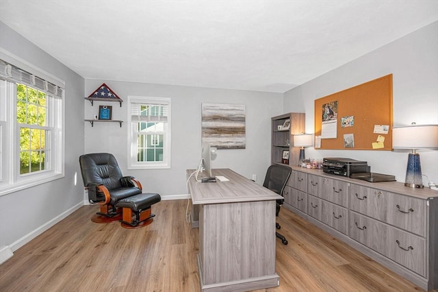 office area featuring light wood finished floors and baseboards