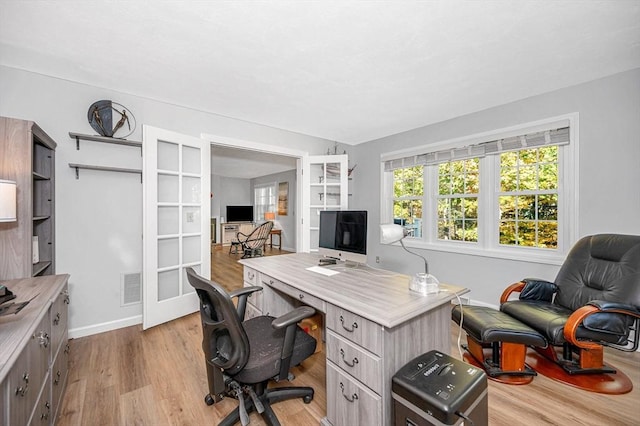 home office featuring light wood-style floors and visible vents