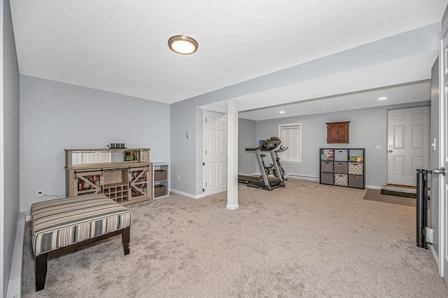 workout area with carpet floors, a baseboard radiator, and baseboards