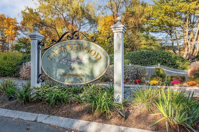 community sign featuring fence