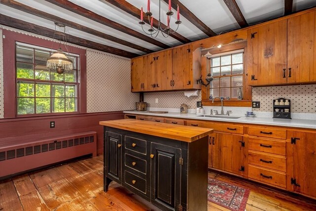 9 Eaton St, Gardner, MA 01440 - kitchen featuring a sink, butcher block counters, radiator heating unit, beamed ceiling, and healthy amount of natural light