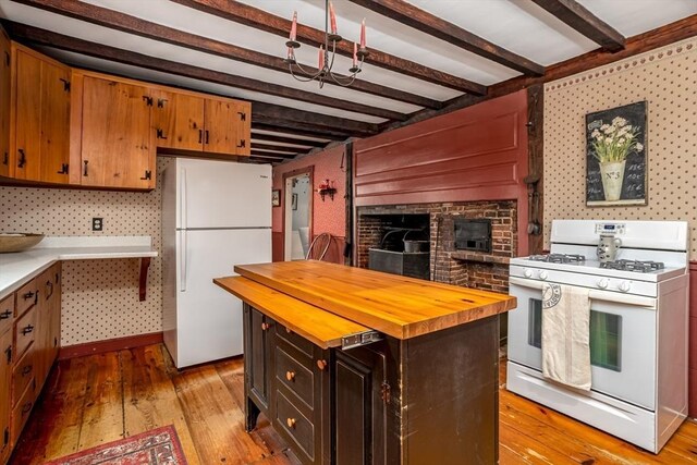 9 Eaton St, Gardner, MA 01440 - kitchen with white appliances, butcher block countertops, beamed ceiling, light wood-type flooring, and a kitchen island