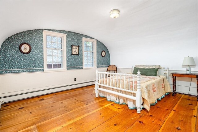 9 Eaton St, Gardner, MA 01440 - bedroom featuring wallpapered walls, lofted ceiling, a baseboard heating unit, and wood-type flooring
