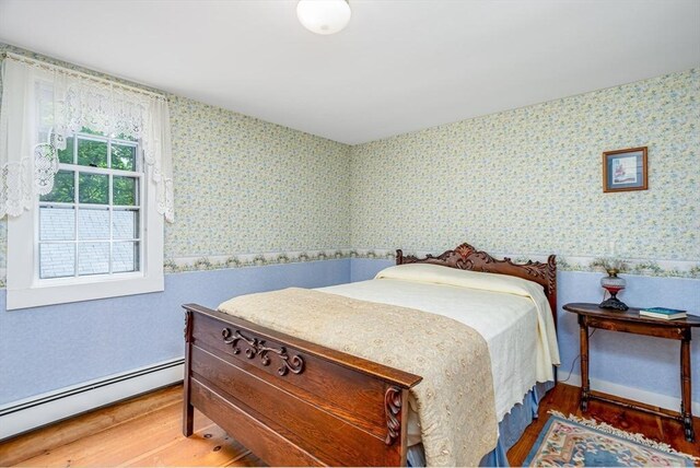 9 Eaton St, Gardner, MA 01440 - bedroom with a baseboard radiator, wallpapered walls, and wood finished floors