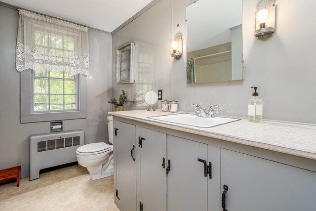 9 Eaton St, Gardner, MA 01440 - bathroom featuring radiator heating unit, toilet, vanity, and a shower with shower curtain