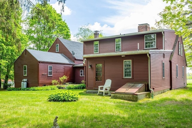 9 Eaton St, Gardner, MA 01440 - back of house featuring a chimney and a lawn