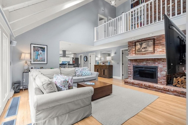 1 Crooked Ln, Manchester, MA 01944 - living room featuring wood finished floors, high vaulted ceiling, and a brick fireplace