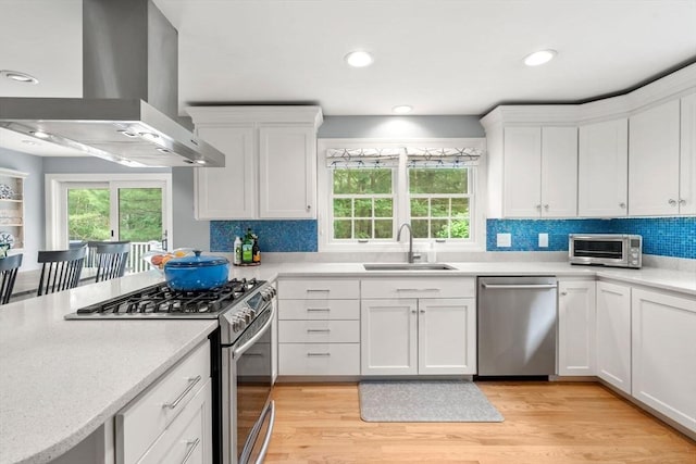 1 Crooked Ln, Manchester, MA 01944 - kitchen featuring appliances with stainless steel finishes, exhaust hood, light countertops, white cabinets, and recessed lighting
