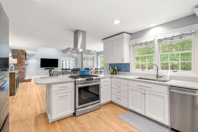 1 Crooked Ln, Manchester, MA 01944 - kitchen featuring stainless steel appliances, extractor fan, a peninsula, open floor plan, and light countertops