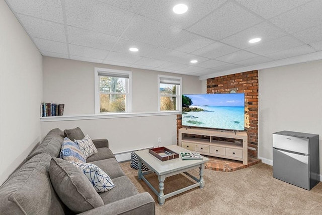 living room with light carpet, baseboard heating, and a paneled ceiling