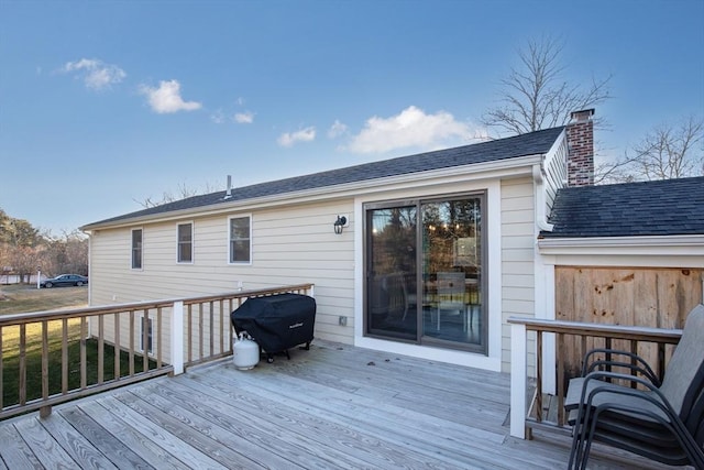 wooden deck with a grill