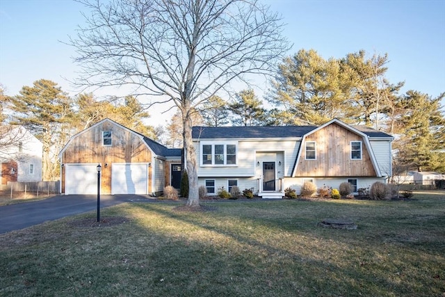 split foyer home with a front yard and a garage