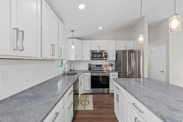 kitchen featuring white cabinets, decorative light fixtures, stainless steel appliances, tasteful backsplash, and sink