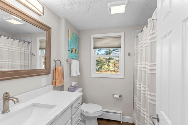 bathroom with toilet, a baseboard heating unit, wood-type flooring, a textured ceiling, and vanity