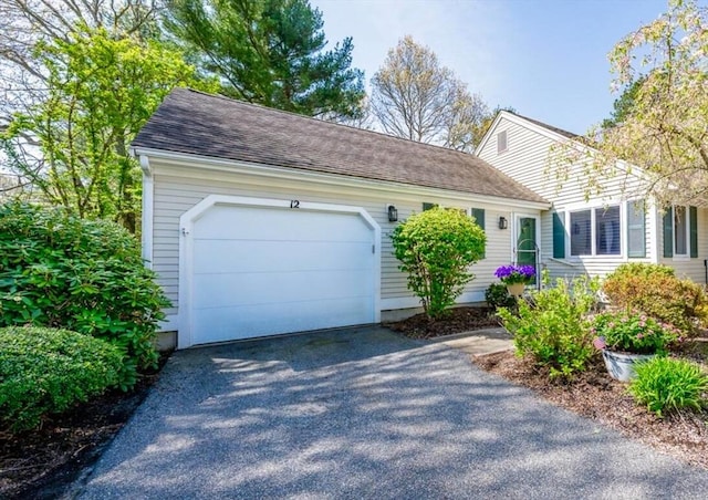 12 Kettle Ln Unit 31, Mashpee, MA 02649 - view of front facade featuring asphalt driveway, an attached garage, and a shingled roof