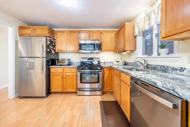 12 Kettle Ln Unit 31, Mashpee, MA 02649 - kitchen with stainless steel appliances, light stone counters, and light wood-style flooring
