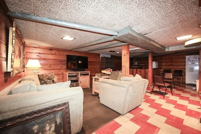 living room with tile patterned floors and wooden walls
