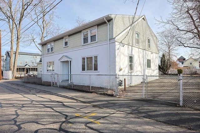 view of front of house with a fenced front yard and a gate