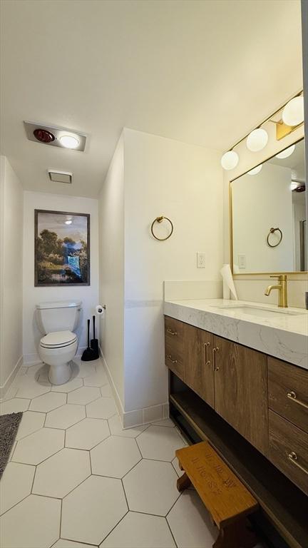 66 Winchester St Phb, Phb, Brookline, MA 02446 - bathroom featuring vanity, baseboards, tile patterned flooring, and toilet