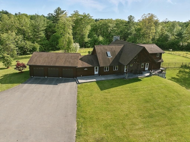 4 Paddock Rd, Rutland, MA 01543 - view of front of home with an attached garage, a wooded view, and driveway