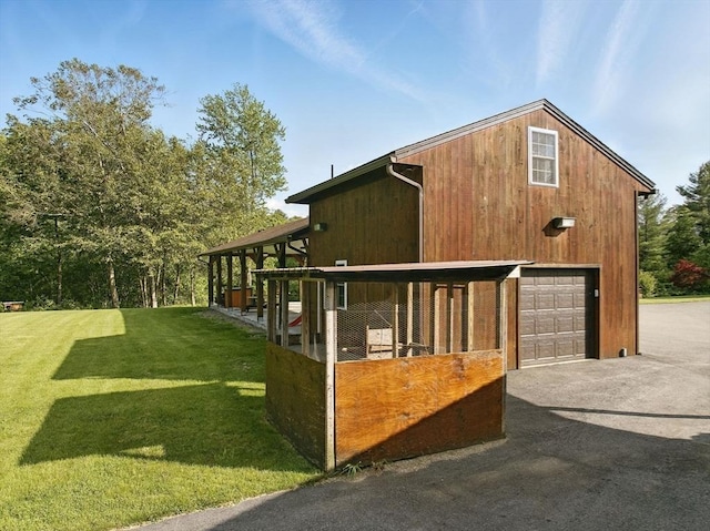 4 Paddock Rd, Rutland, MA 01543 - view of property exterior featuring a garage, an outdoor structure, and asphalt driveway