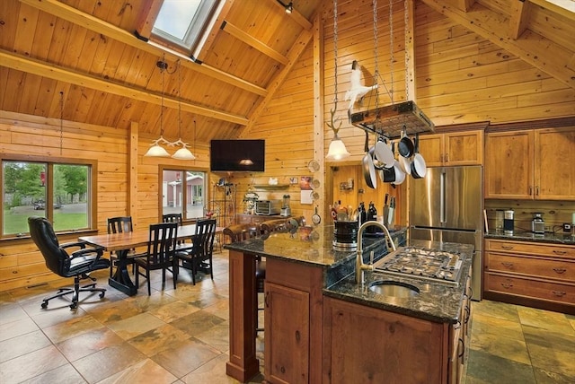 4 Paddock Rd, Rutland, MA 01543 - kitchen featuring wood ceiling with exposed beams, wooden walls, brown cabinetry, dark stone counters, and high vaulted ceiling