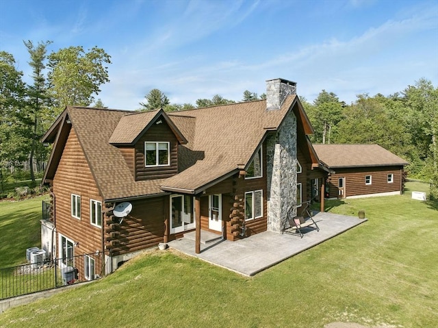 4 Paddock Rd, Rutland, MA 01543 - rear view of house with log exterior, a shingled roof, a patio, a chimney, and central AC unit