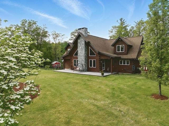 4 Paddock Rd, Rutland, MA 01543 - rear view of house featuring a chimney, a patio, and log siding