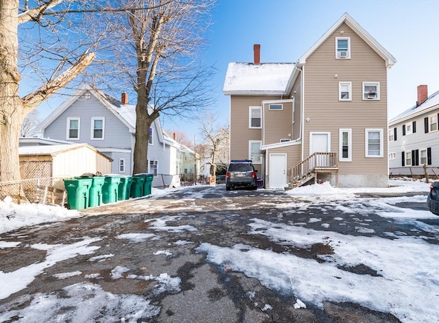 view of snow covered rear of property