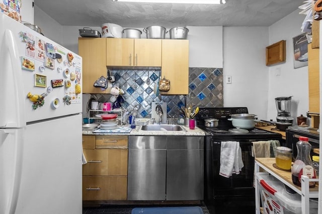 kitchen featuring white refrigerator, sink, decorative backsplash, a textured ceiling, and black / electric stove